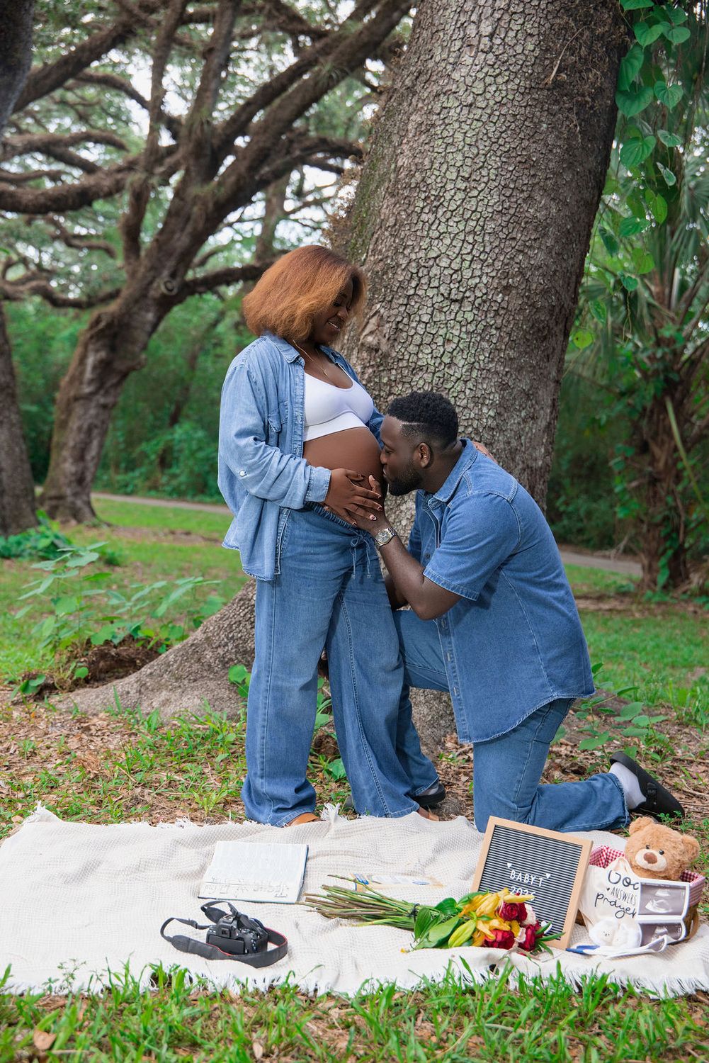 Expecting couple in denim at an outdoor maternity picnic